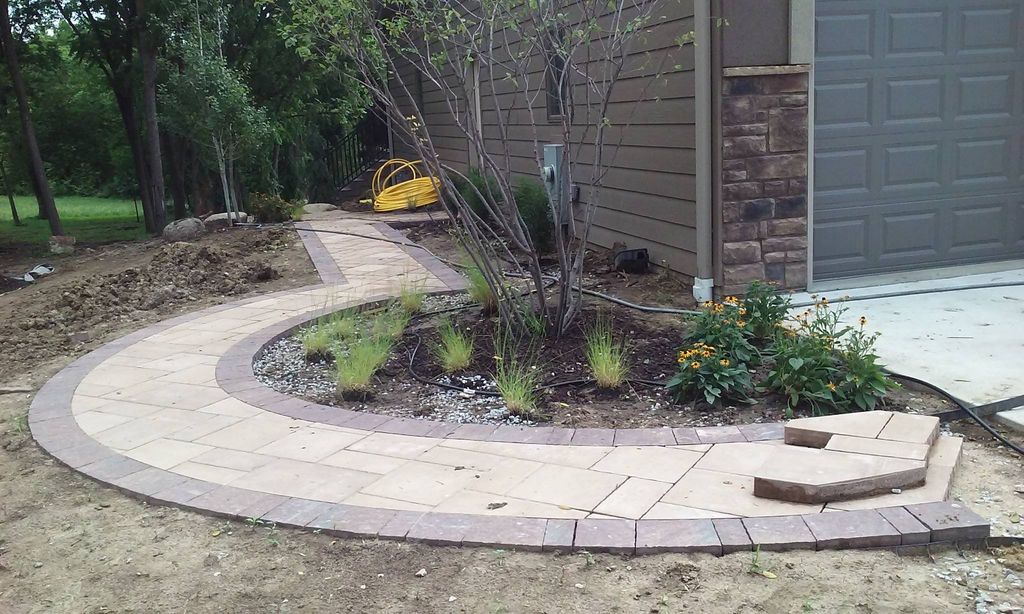 Paver walkway shrub and tree installation.