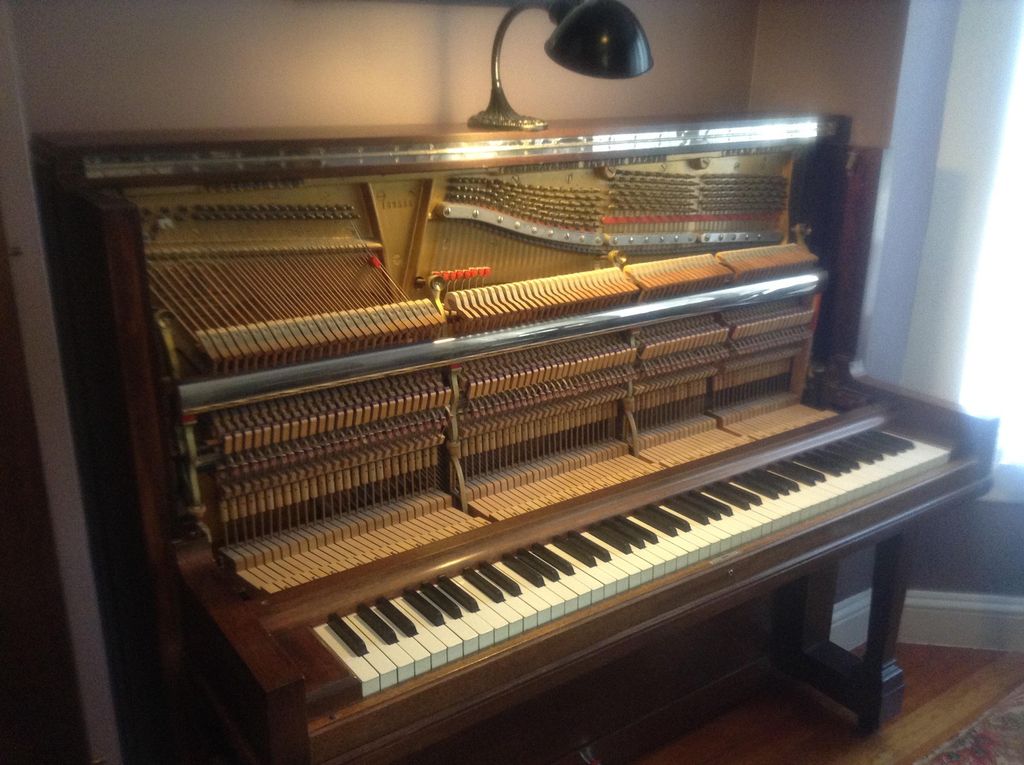 Preparing to tune a Steinway vertical piano.