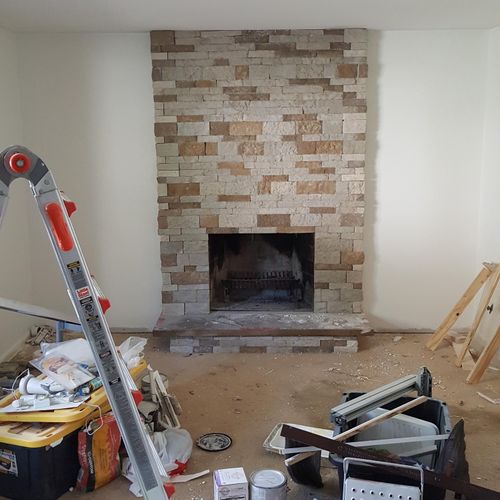 Fireplace was refinished with stone and drywall wa