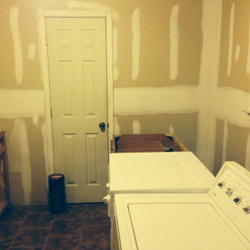 Sheetrocking and painting laundry room. Hanging ca