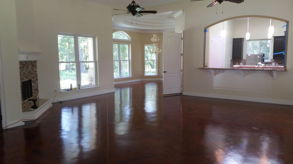Large family room with 14' ceiling and stained con