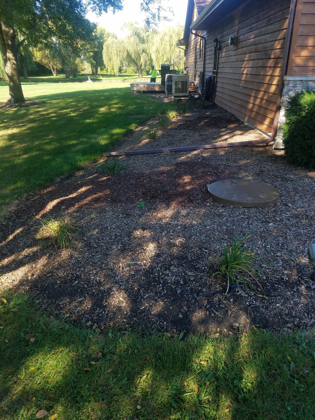 Replacing mulch with river rock.