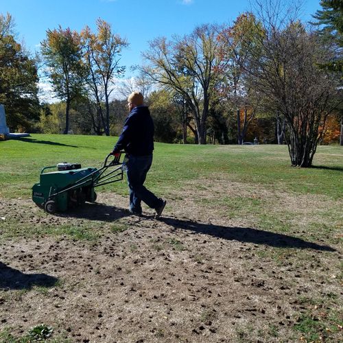 Aerating the parks land and planting new grass see