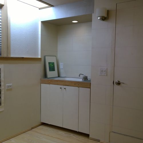 Corner of basement office with lavatory and full b
