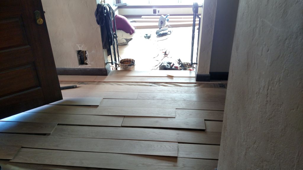 Installing plank in the hall, looking down into th