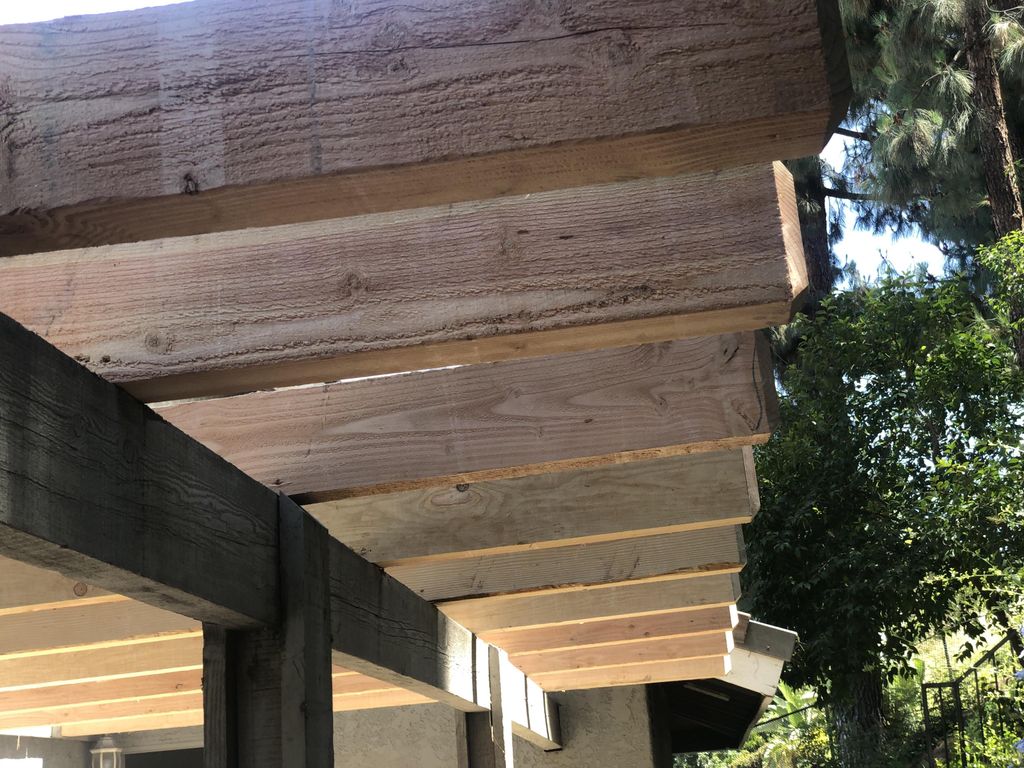 New ceiling joists installed on an exterior patio.