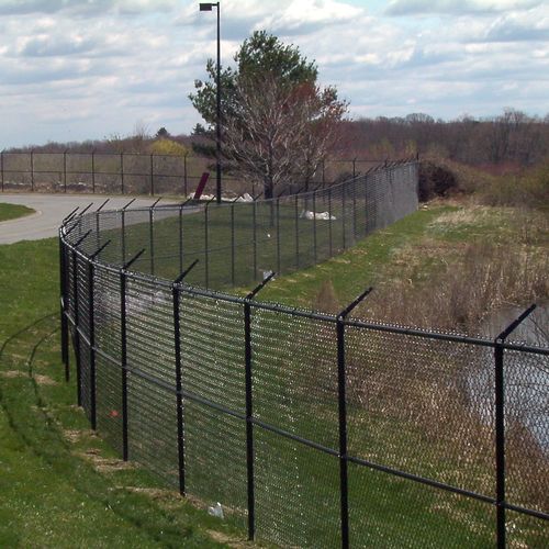black vinyl fence with barbedwire