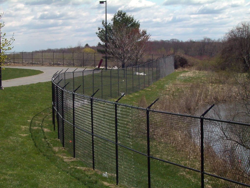 black vinyl fence with barbedwire