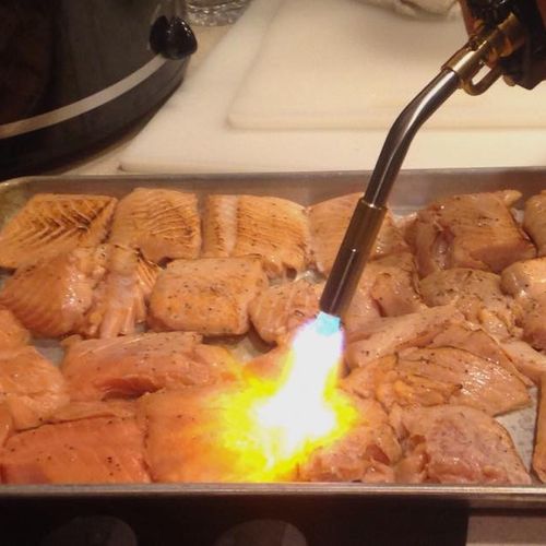 Sous Vide Salmon being seared with a blow torch.
