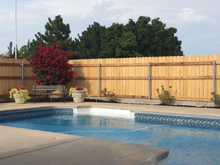 retaining wall, fence and flower beds