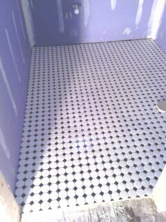 Black and white mosaic tile in bathroom.