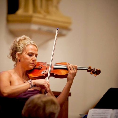 Natalie Wright performing violin solo at a wedding