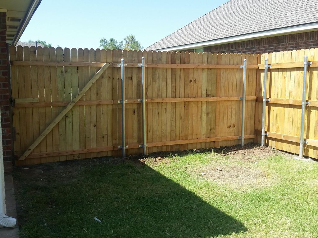 Fence and gate with metal posts.