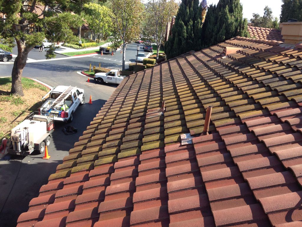 Steam pressure washing tile rooftop to make it loo