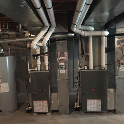 Two Trane Upflow Furnaces and AC in basement.