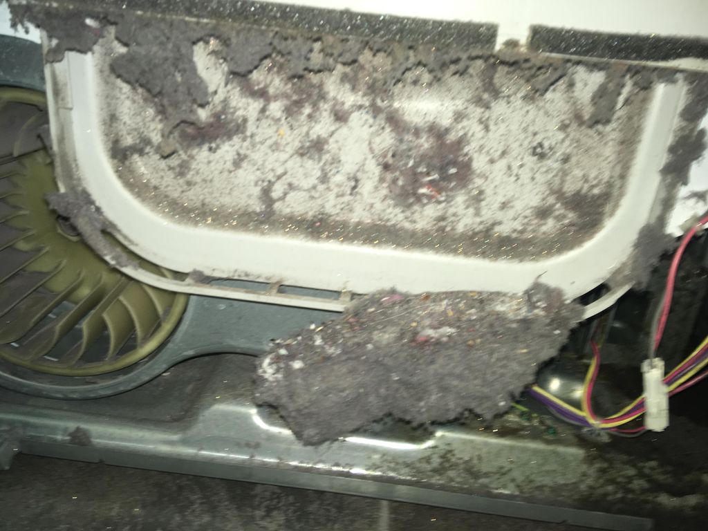 A dryer with the front panel taken off. 