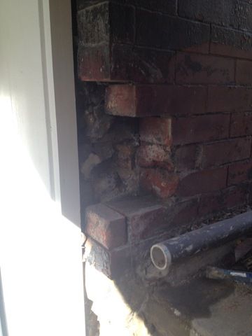 Before photo of crumbling brick on doorframe