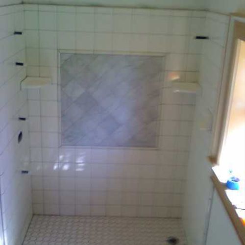 Custom shower surround with inlayed center designe
