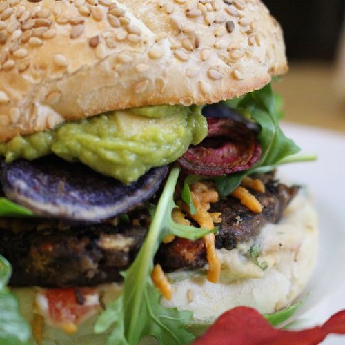 Homemade veggie burger, topped with avocado mash, 