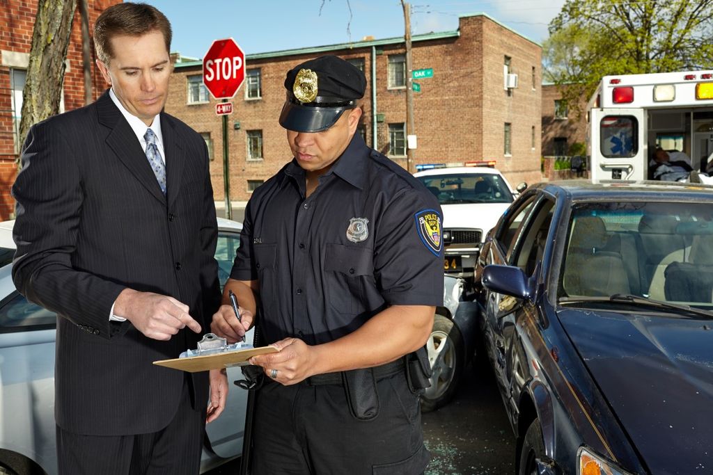 With an officer on the scene of a car accident.