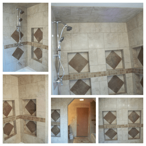 Custom tile shower with shelves in it and in the w