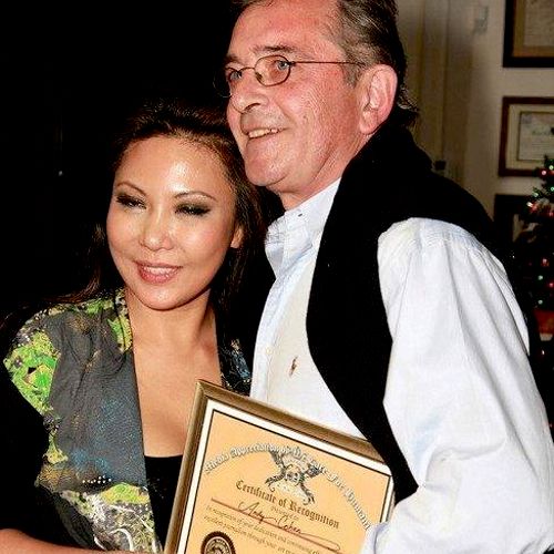 Andy with Maria Amor Torres receiving an award for
