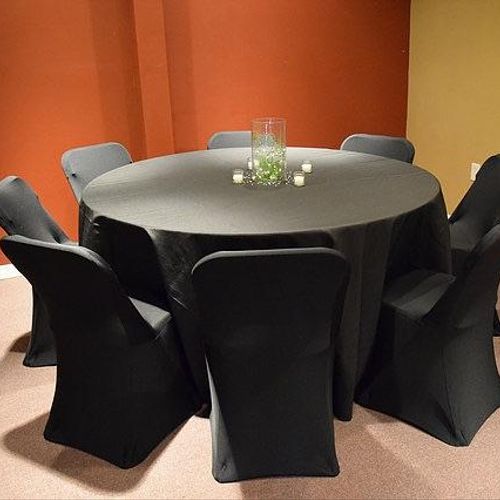 all black round tables with table cloth and chair 