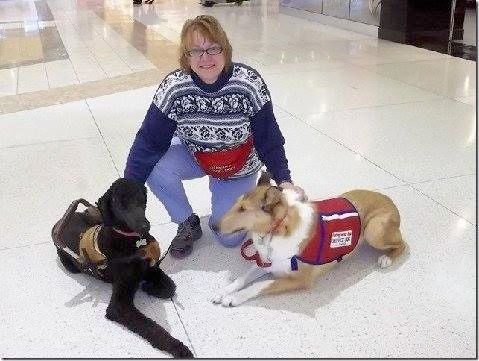 Cindi with 2 of the service dogs that she trained.