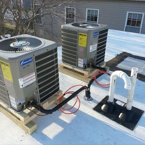 twin 2 ton a/c condensers installed on a roof.