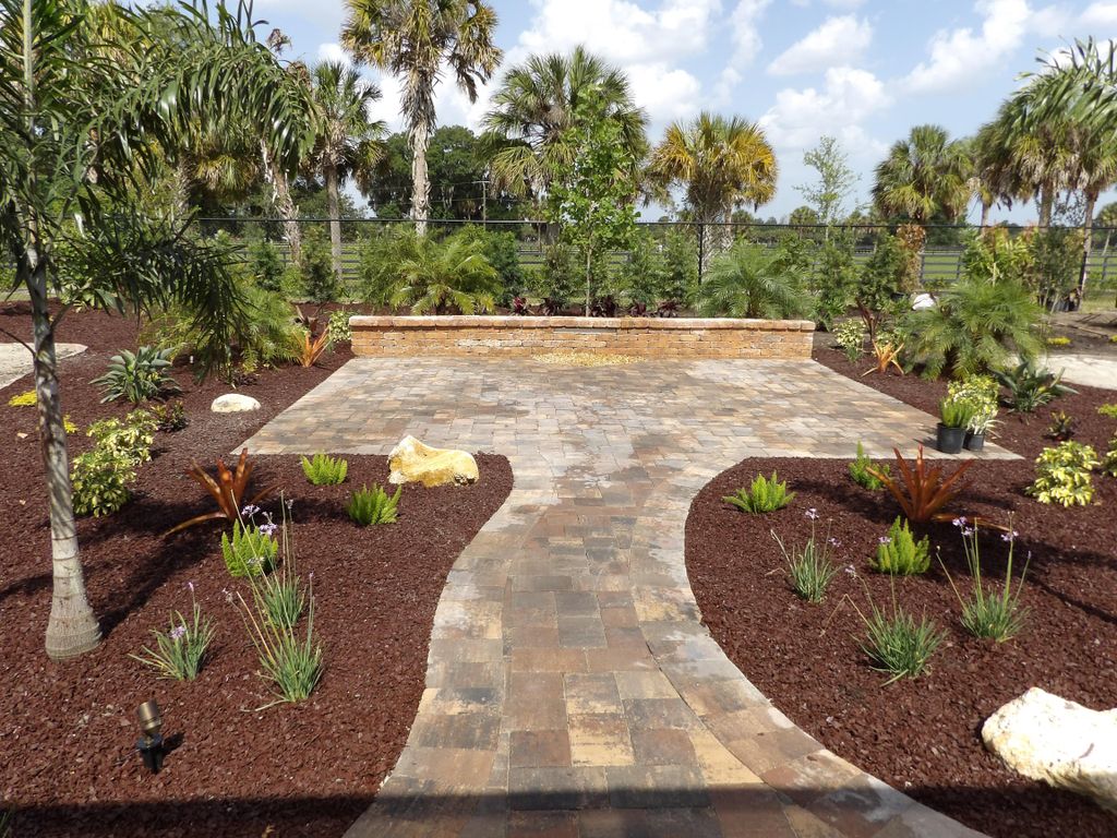 Paver patio with walkways and waterfall wall.