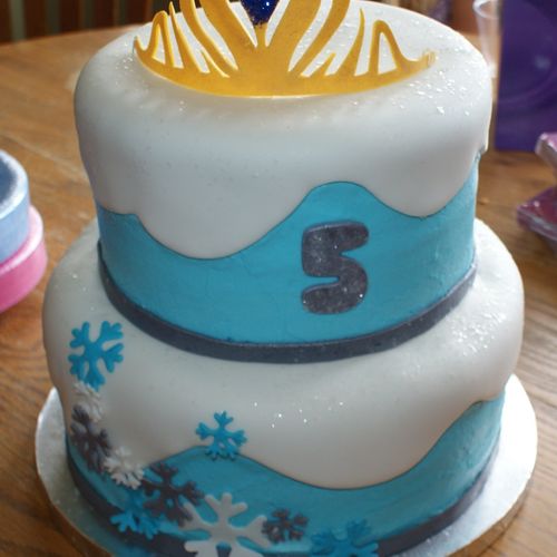 Birthday cake with Frozen theme. Tiara on top is g