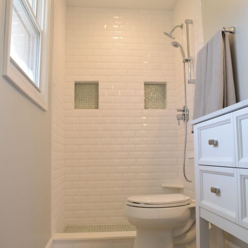 Custom shower stall with subway tile, glass niches