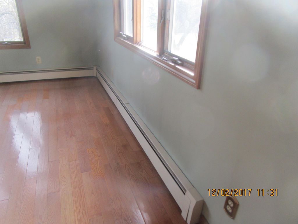 The black marks above this baseboard heating syste