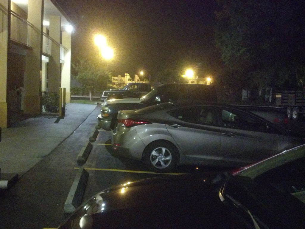 Cheating spouse vehicle (grey) located at night in