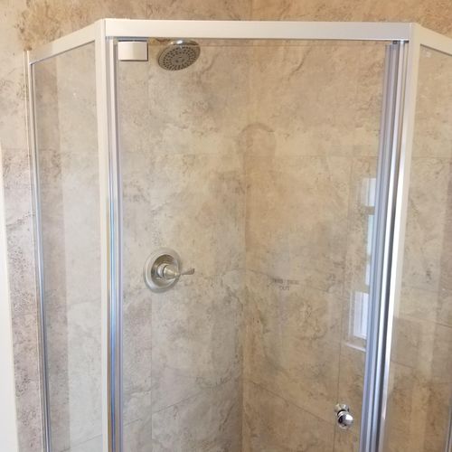 Bathroom shower surround installed.