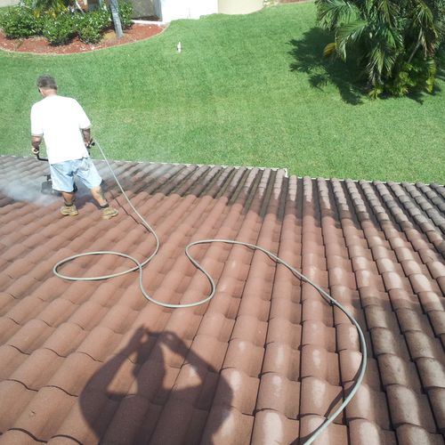 Residential tile roof cleaning in progress.