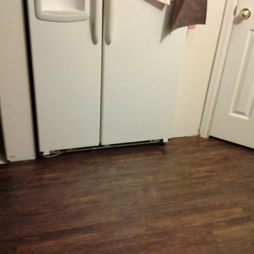 We installed the flooring under the fridge.