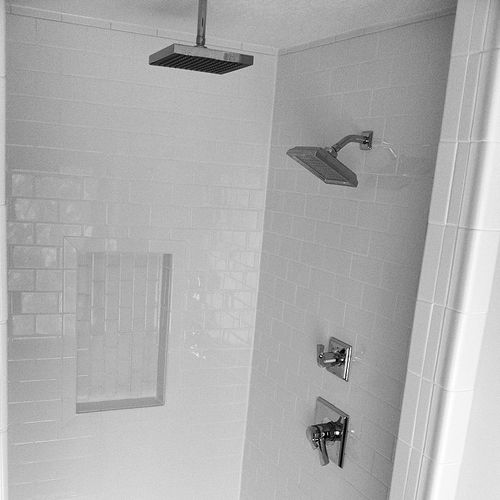 Bathroom shower remodel featuring white subway til