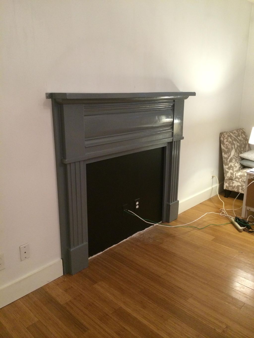 Antique fireplace surround refinished and mounted 