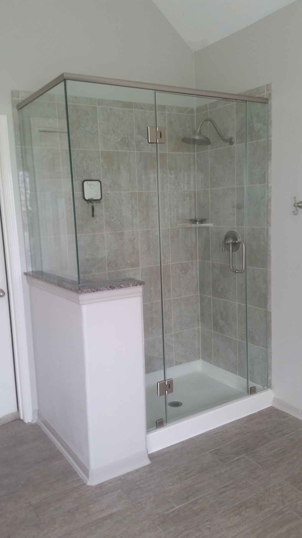 Frameless shower enclosure