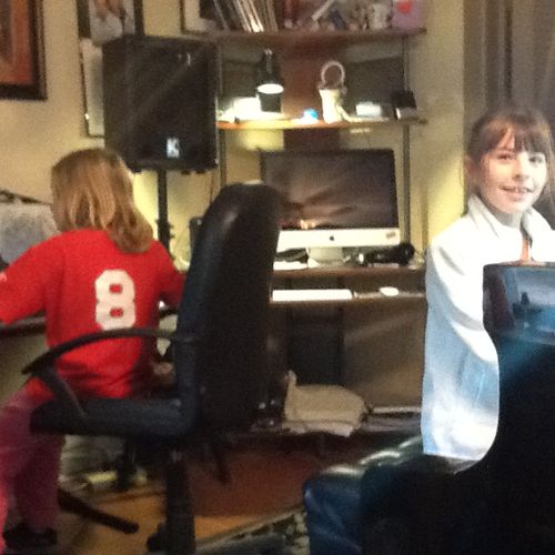 Students play keyboard ensemble in studio