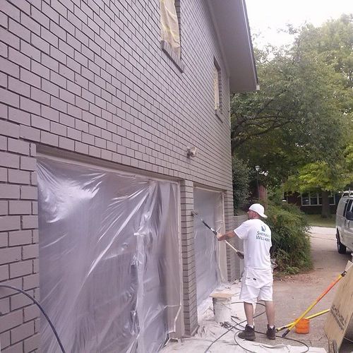 Completing second coat on brick