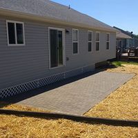 Paver patio, lattice and seed and straw.