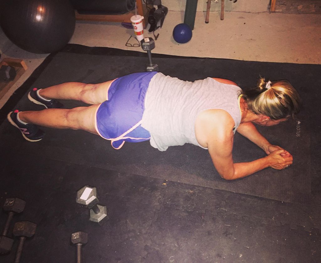 Client planking in her garage gym