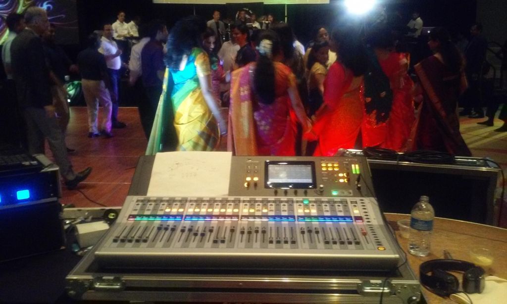 Mixing a live band while people dance at a corpora