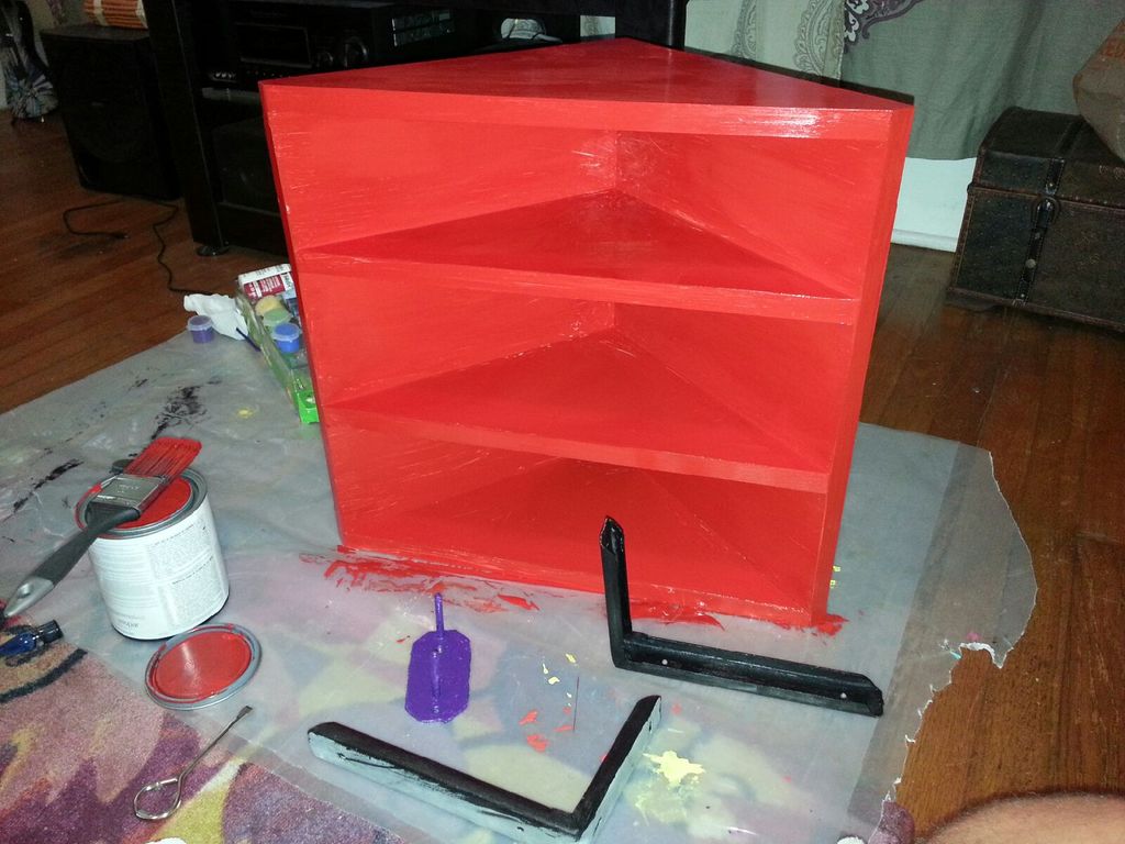 Repurposed white corner shelf, painted cherry red.