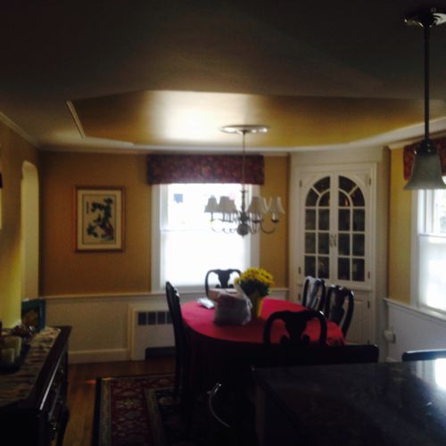 Dining room including ceiling with decorative pane
