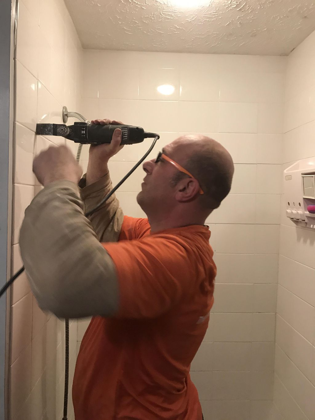 Here we have Jason removing old grout to replace w