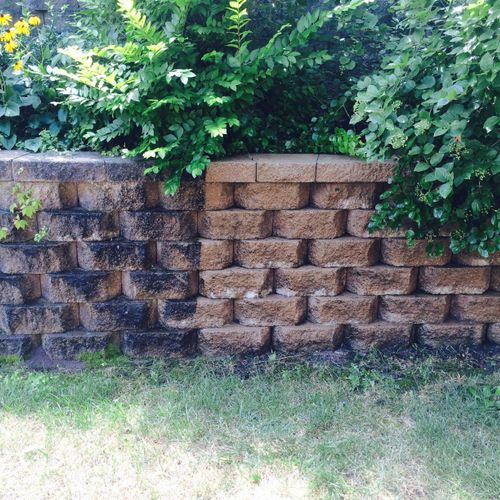 pressure washing of retaining wall before/after.