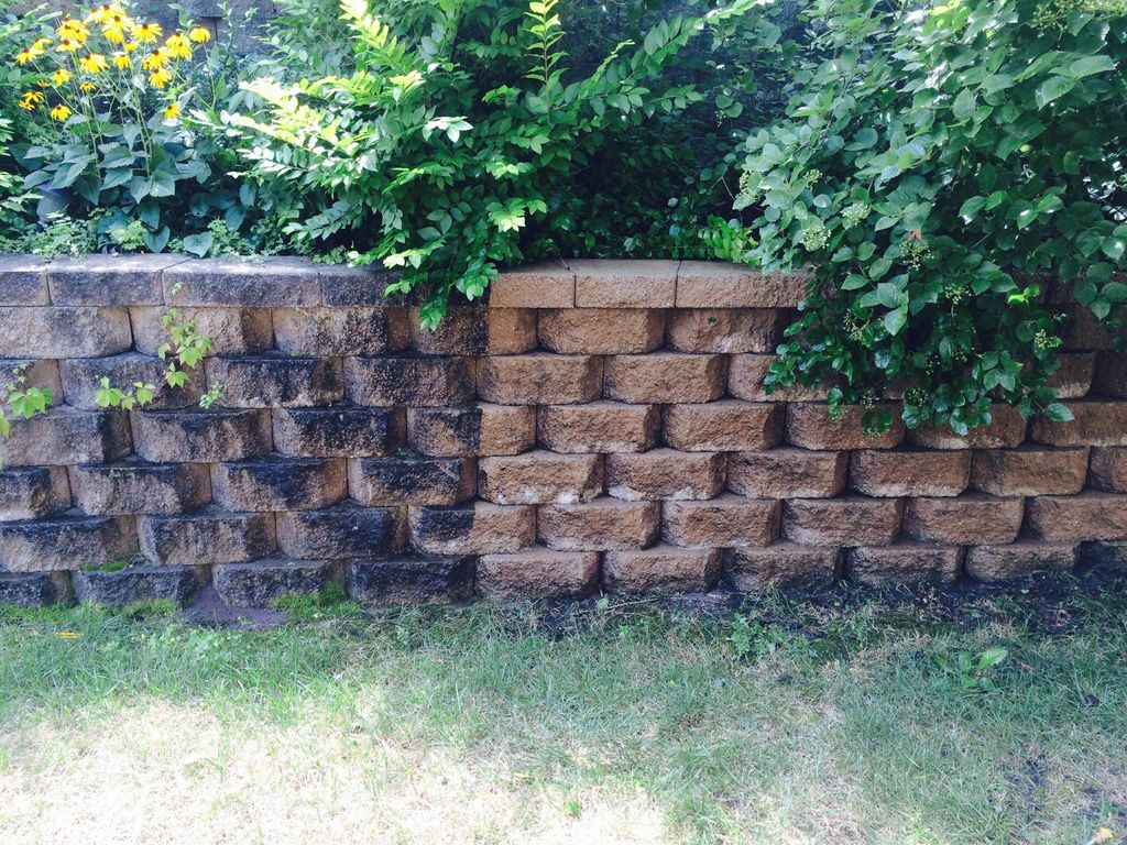 pressure washing of retaining wall before/after.